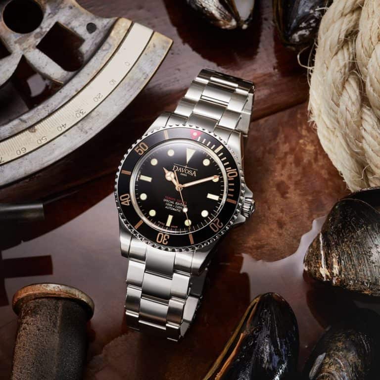 Charming silver watch amidst water surrounded by seashells and nautical items creating a marine theme in photo advertising After