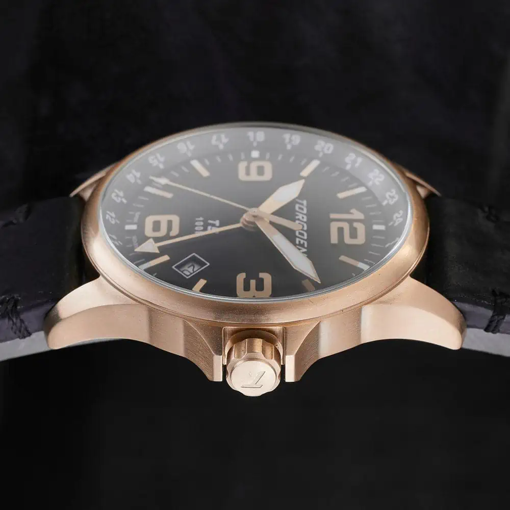 Classic gold watch with an elegant black strap on a sleek black background shines in packshot ecommerce Before