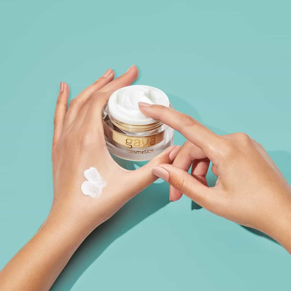 Cosmetics product photography of elegant fingers with light cream on quality photo studio tranquil backdrop