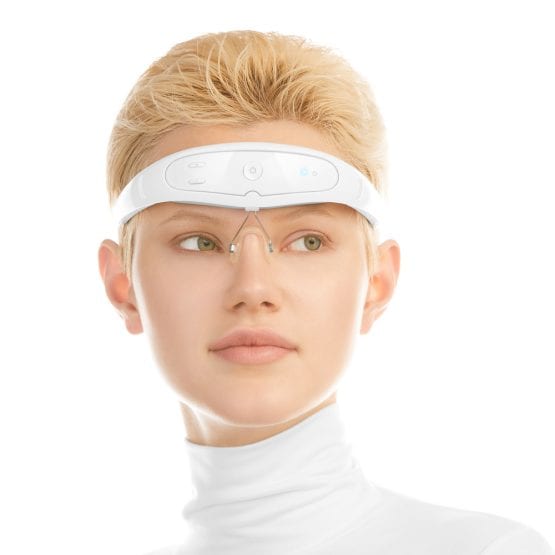 Migraine treatment device on girls head light tone in white background product photography