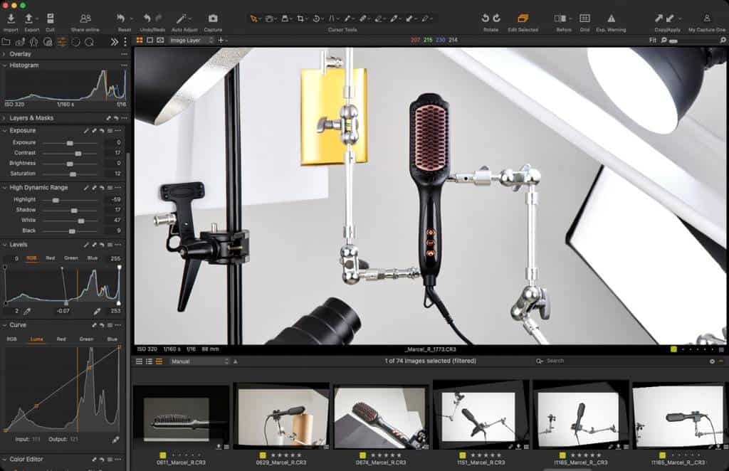 Behind-the-scenes shot of a professional amazon product shoot featuring a hair straightener. The setup includes studio lights, camera adjustments, and the product displayed at a custom angle to ensure high-quality amazon fba product photos.