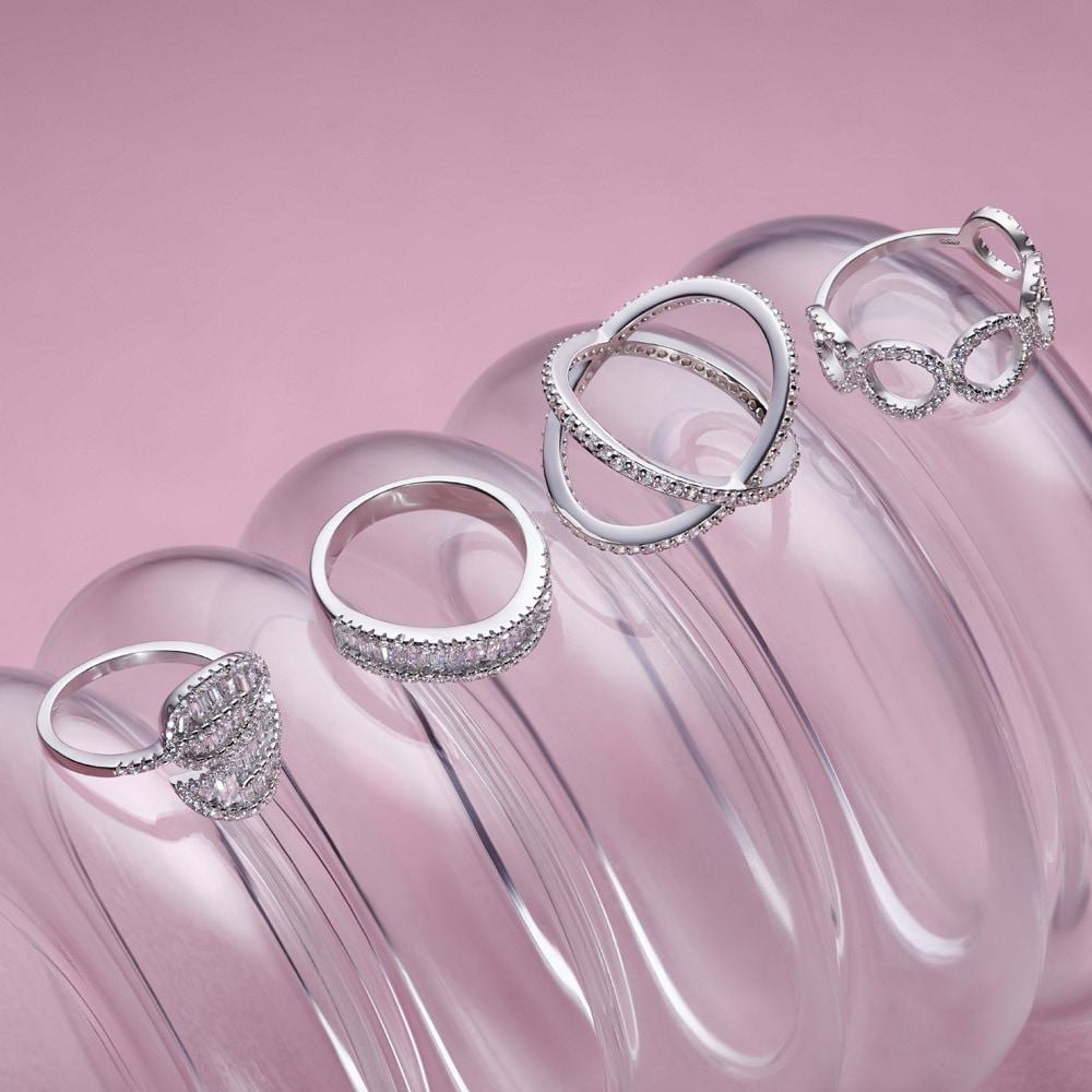 Silver rings bundle on pink in lifestyle photography studio reflecting professional photography for social media charm