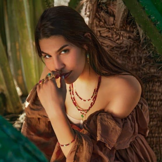 Woman with jewelry near palms in lifestyle product photography services showcasing advertisement photographer allure