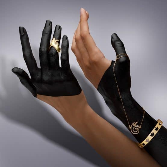 Womans hands adorned with gold jewelry in lifestyle photography studio capturing advertising photography beauty